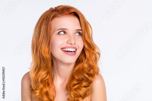 Photo portrait of pretty girl with wavy ginger hair laughing dreamy looking empty space isolated on white color background
