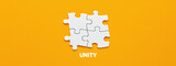 Four puzzle pieces connected to each other with the word unity. Synergy, integration or solidarity
