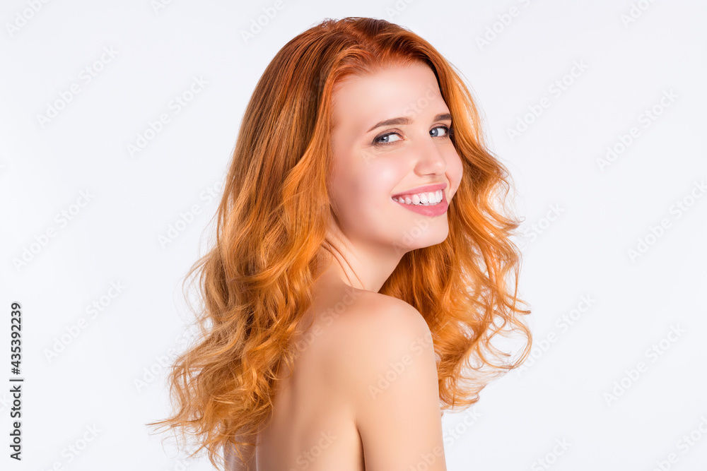 Side profile photo portrait of girl with curly red hair laughing happy with naked shoulders isolated white color background Side profile photo portrait of girl with curly red hair laughing happy with naked shoulders isolated white color background
