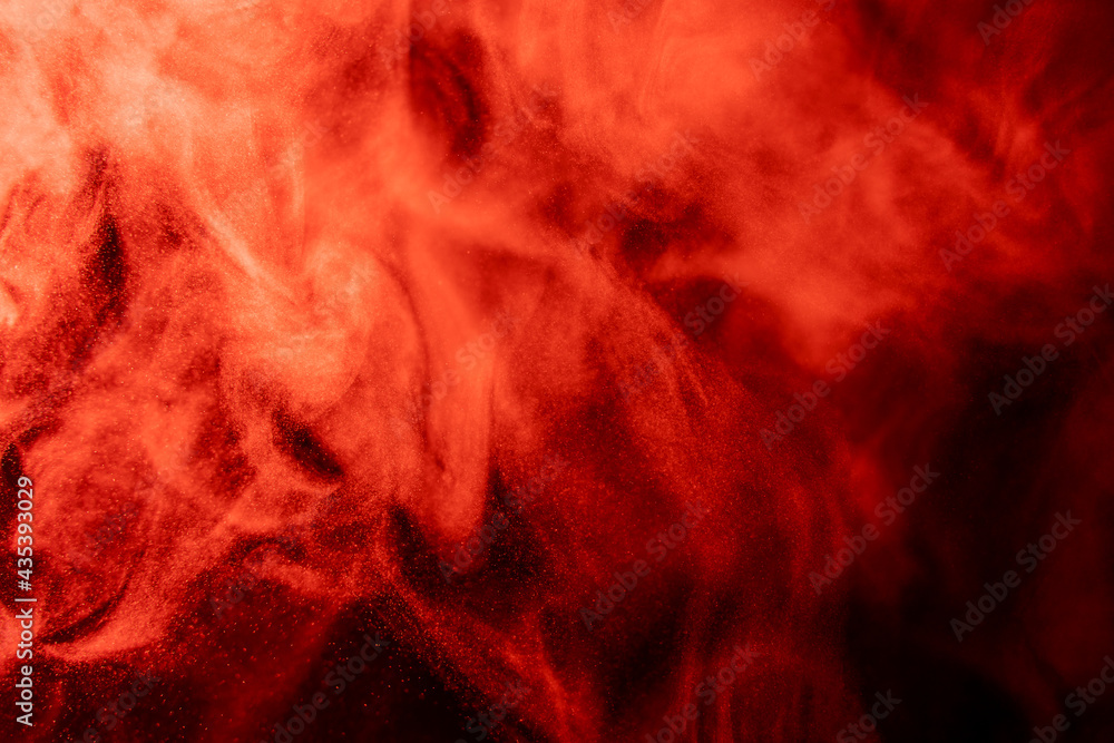 Red smoke on a black background. Dense steam in red light. Abstract foggy background.
