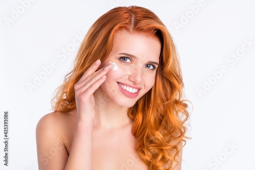 Photo portrait of woman curly red hair smooth skin applying moisturizer cream isolated white color background