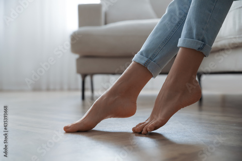 Barefoot woman at home, closeup. Floor heating system © New Africa