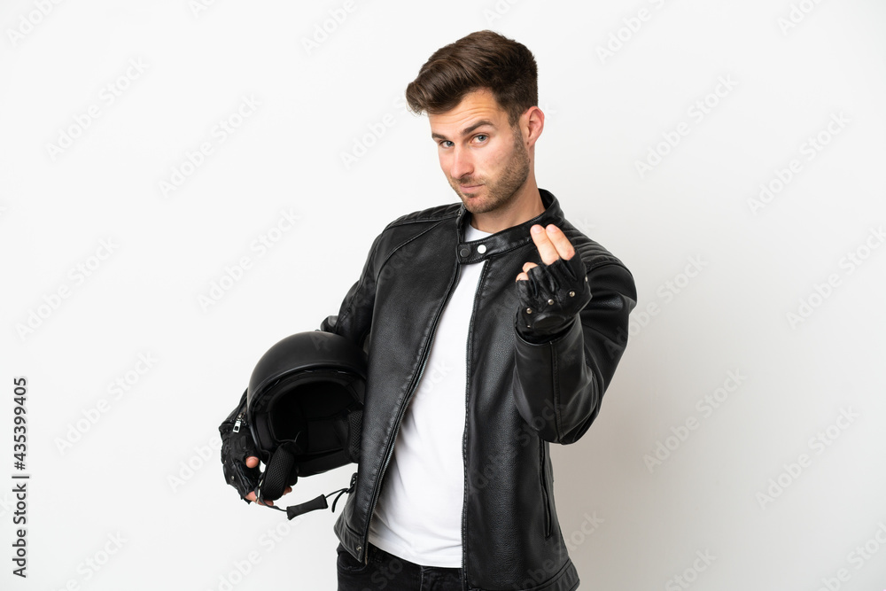 Young caucasian man with a motorcycle helmet isolated on white background making money gesture Young caucasian man with a motorcycle helmet isolated on white background making money gesture