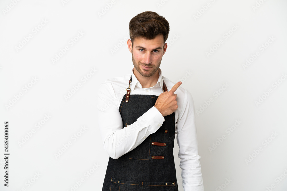 Restaurant caucasian waiter isolated on white background pointing to the side to present a product Restaurant caucasian waiter isolated on white background pointing to the side to present a product