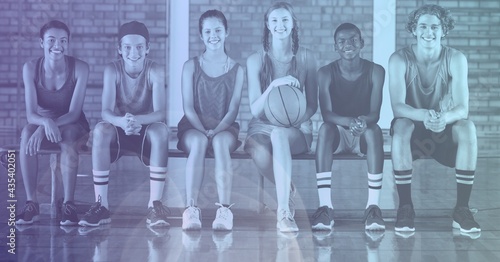 Composition of smiling team of school basketball players with purple tint