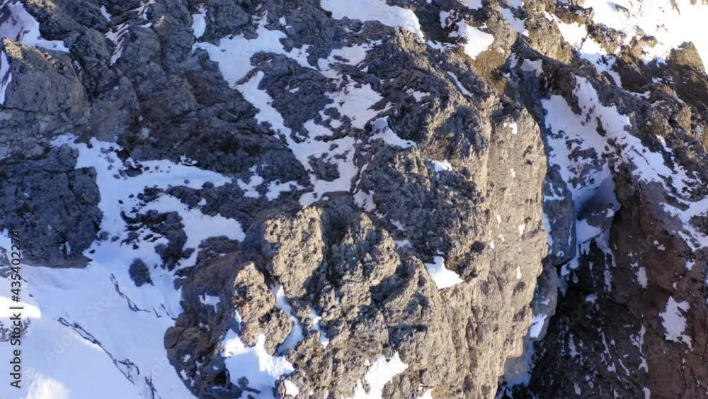 Scenic top view from drone of alpine arc of mountain with rocky summits for alpinism climbing, aerial bird's eye on spectacular nature environment, winter season and snowscape Scenic top view from drone of alpine arc of mountain with rocky summits for alpinism climbing, aerial bird's eye on spectacular nature environment, winter season and snowscape