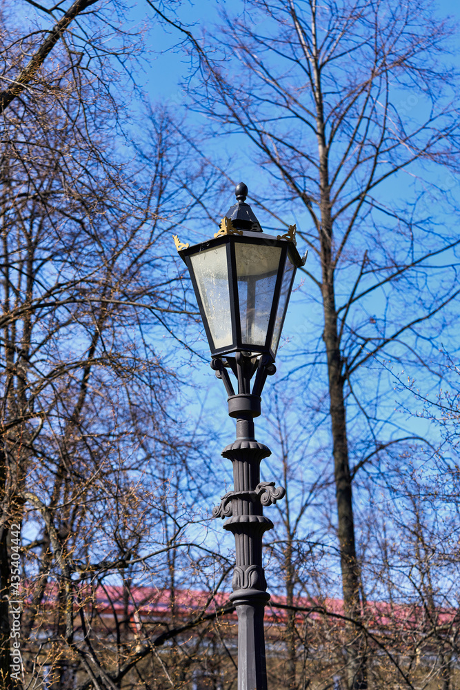 Vintage gas street lamp on a background of blue sky