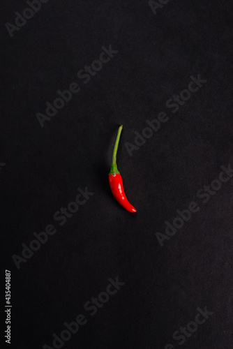 red chili pepper on black background