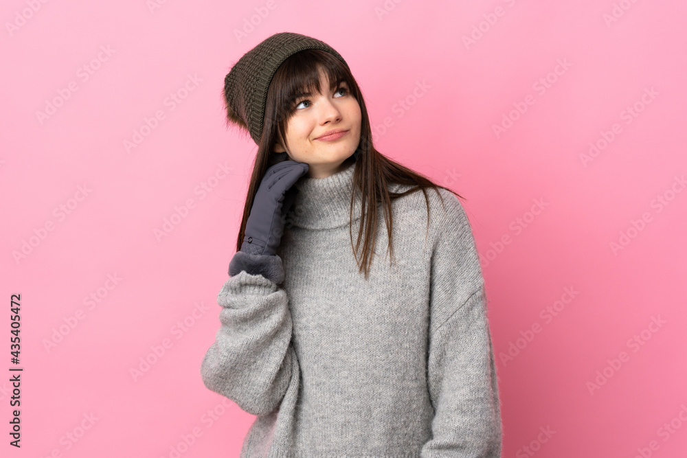 Teenager Ukrainian girl with winter hat isolated on white background thinking an idea Teenager Ukrainian girl with winter hat isolated on white background thinking an idea