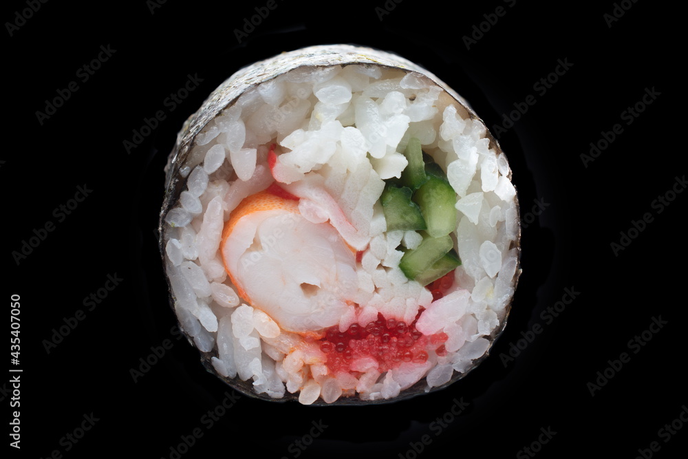 single maki roll isolated on black background single maki roll isolated on black background