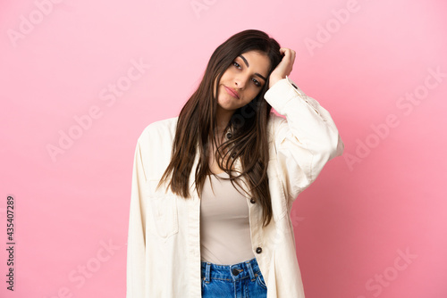 Young caucasian woman isolated on pink background with an expression of frustration and not understanding