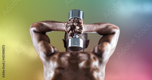 Composition of rear view of muscular strong african american man lifting dumbbells