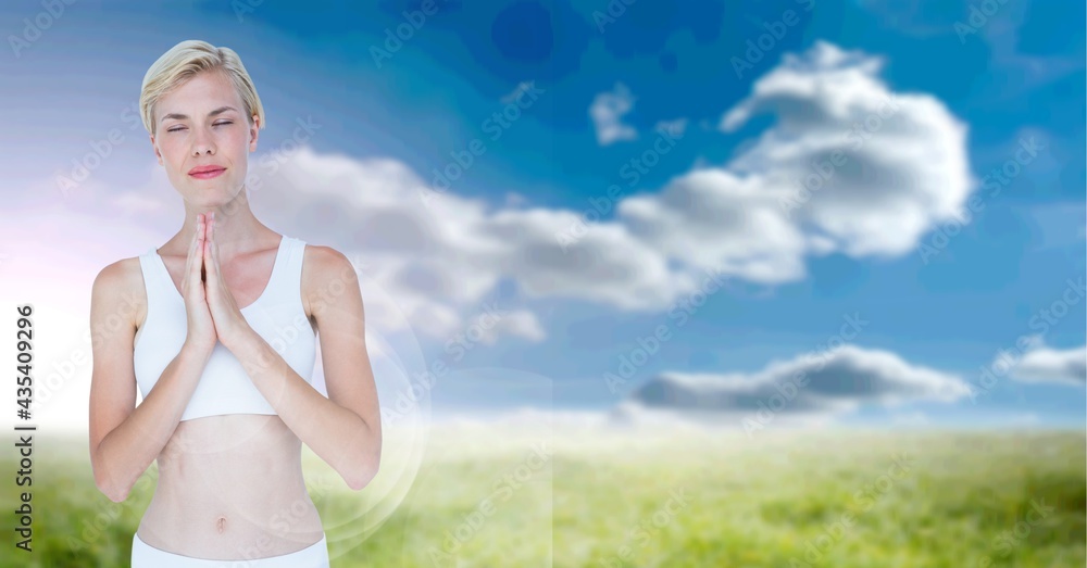 Composition of caucasian woman meditating with eyes closed with copy space over clouds and blue sky