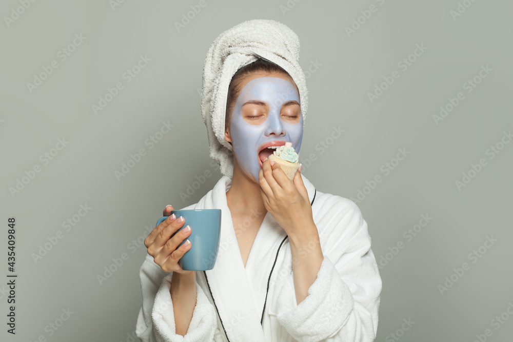 Female routine and breakfast. Young cute woman in cosmetic face mask eating  breakfast and drinking coffee Stock Photo | Adobe Stock