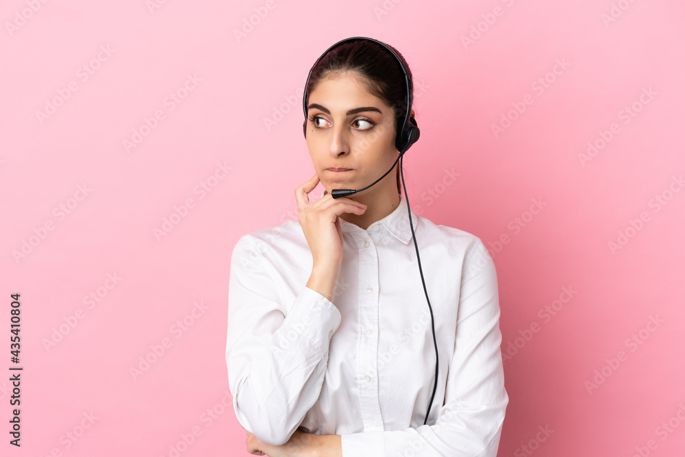 Young telemarketer over isolated background having doubts and thinking Young telemarketer over isolated background having doubts and thinking
