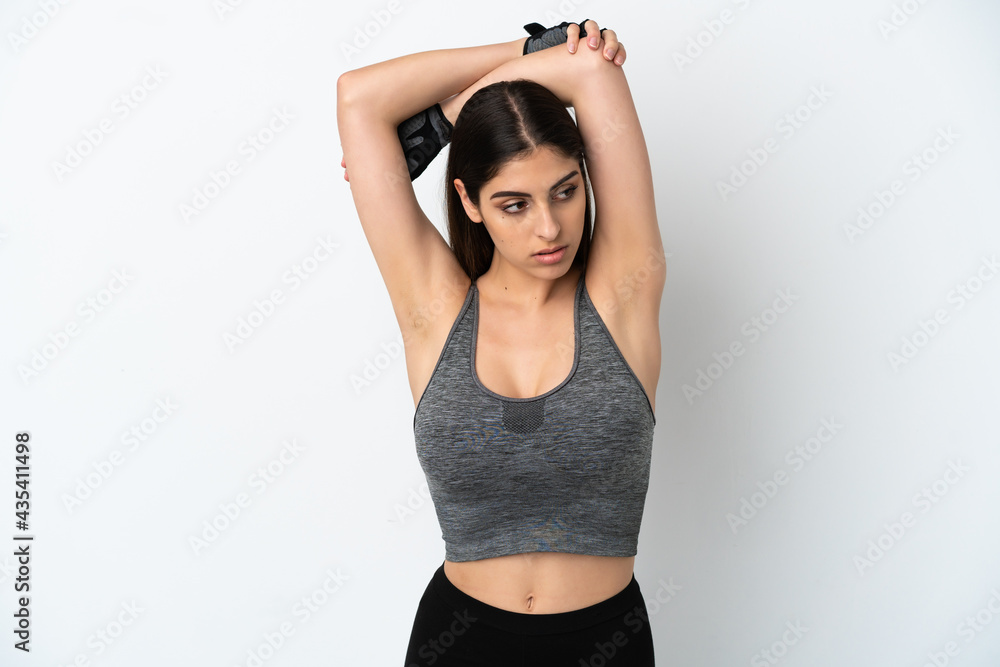 Obraz premium Young caucasian woman isolated on white background stretching