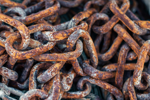 Rusty chains on black background, close up.