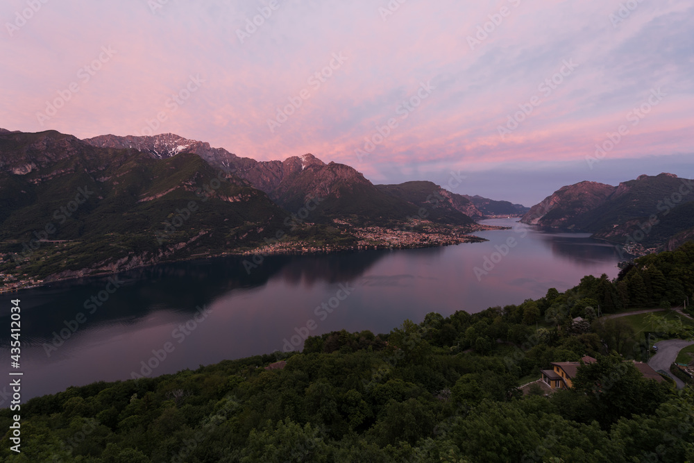 Sunset view over Lecco branch of lake Como from Civenna with pink sky.