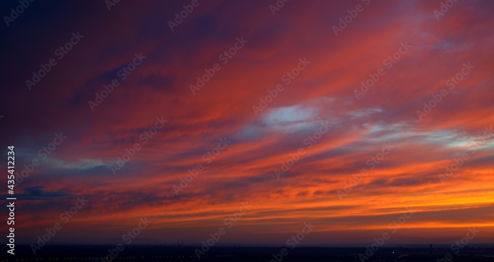 Beautiful orange bright sunset. The clouds are painted in the colors of the sunset. Bright colors of the sky. Bloody Sunset Beautiful orange bright sunset. The clouds are painted in the colors of the sunset. Bright colors of the sky. Bloody Sunset