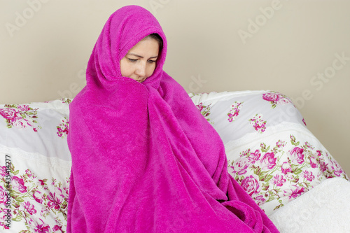 Visibly dejected woman with flu symptoms photo