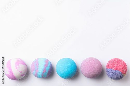 Colorful bath bombs on white background, flat lay. Space for text