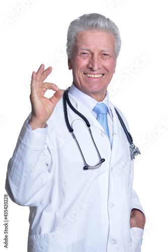 portrait of senior male doctor with stethoscope showing ok