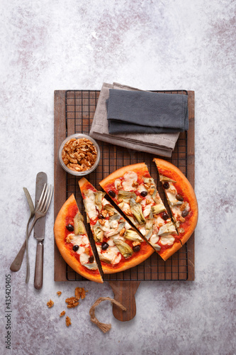 Pizza with tomato sauce artichokes and olives (ph. Marianna Franchi) photo