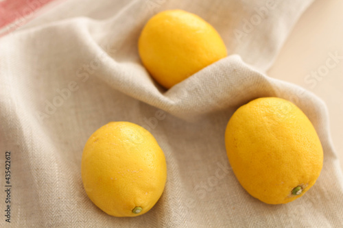 Yellow Lemons on the table. Summer day in Kitchen. Three fruits photo