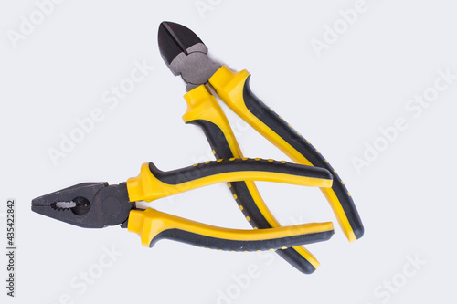 Two pairs of pliers on white background.