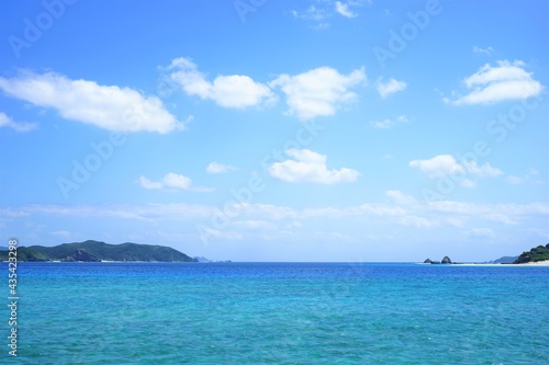 Fototapeta Naklejka Na Ścianę i Meble -  Beautiful summer scenery of Zamami port pier with lighthouse in Okinawa, Japan - 日本 沖縄 座間味港 ピア 青い海	