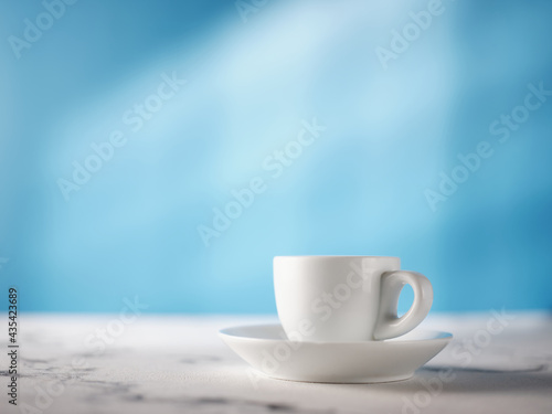 White espresso cup on the kitchen table