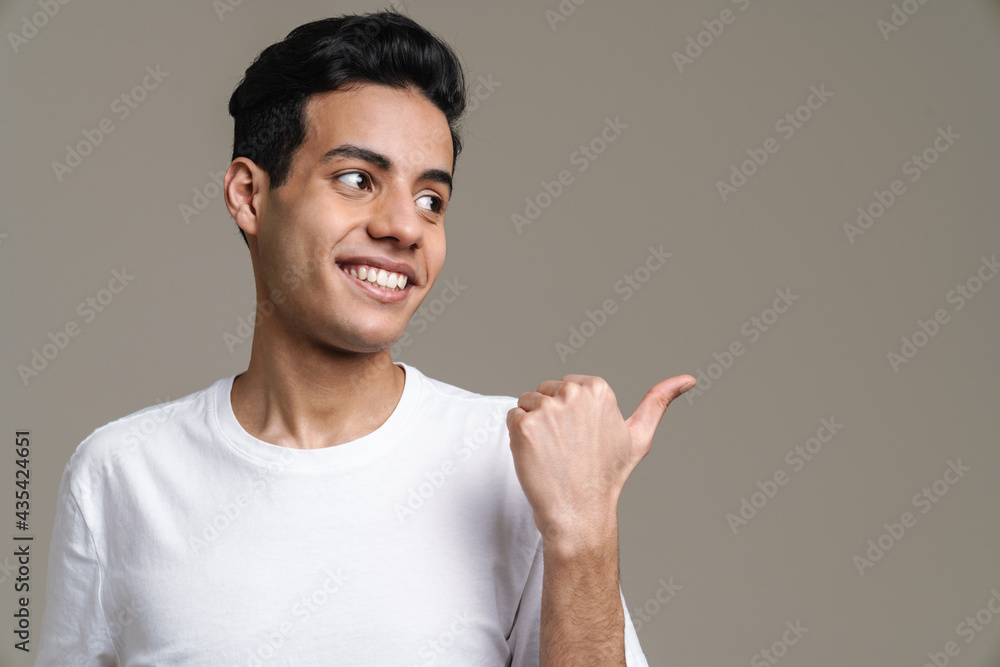 Smiling young brunette man in t-shirt standing Smiling young brunette man in t-shirt standing