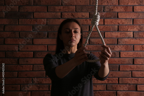 Wallpaper Mural Depressed woman with rope noose near brick wall Torontodigital.ca