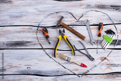 Various construction tools on wooden background. photo