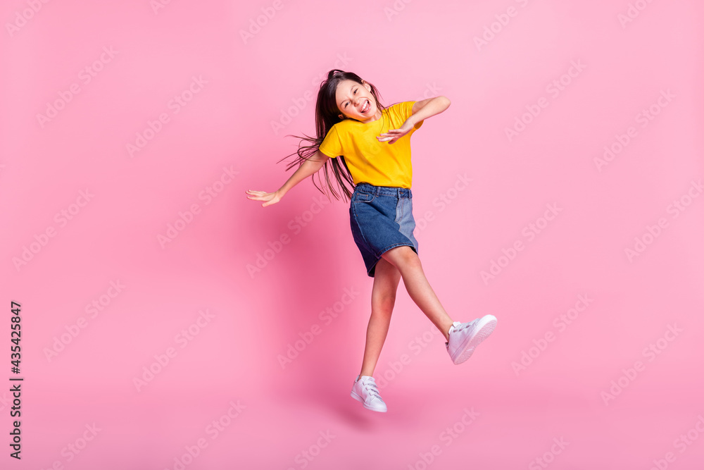Full length body size view of attractive cheerful overjoyed girl jumping having fun fooling isolated over pink pastel color background