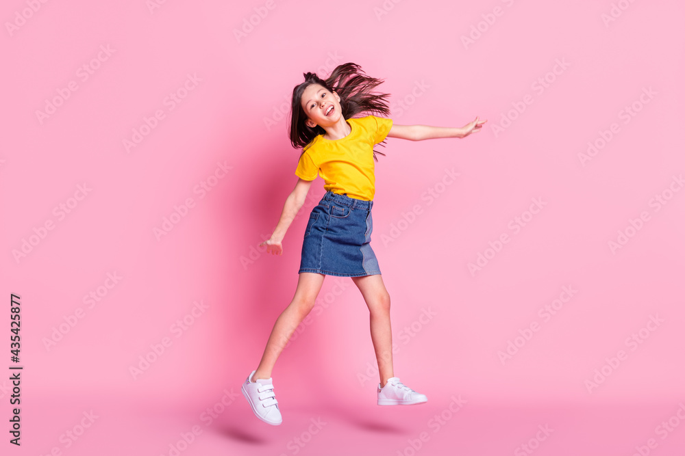 Full lelngth photo of attractive nice happy llittle girl jump up good mood weekend isolated on pink color background Full lelngth photo of attractive nice happy llittle girl jump up good mood weekend isolated on pink color background