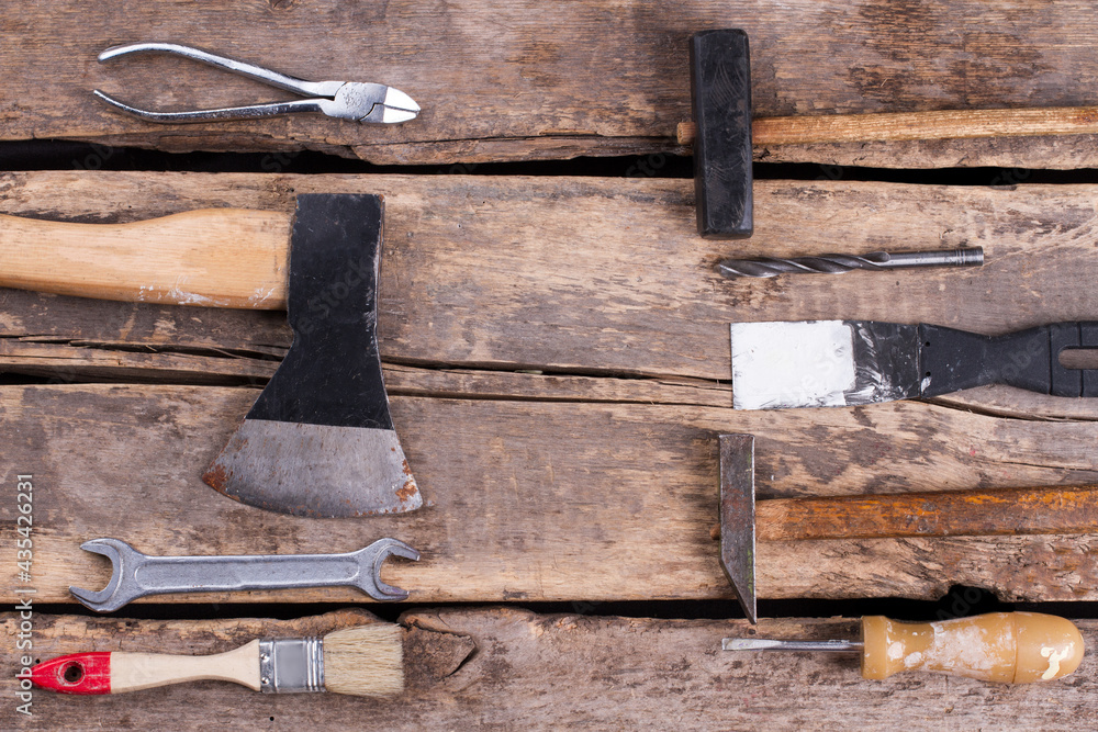 Set of construction tools on old wooden background.