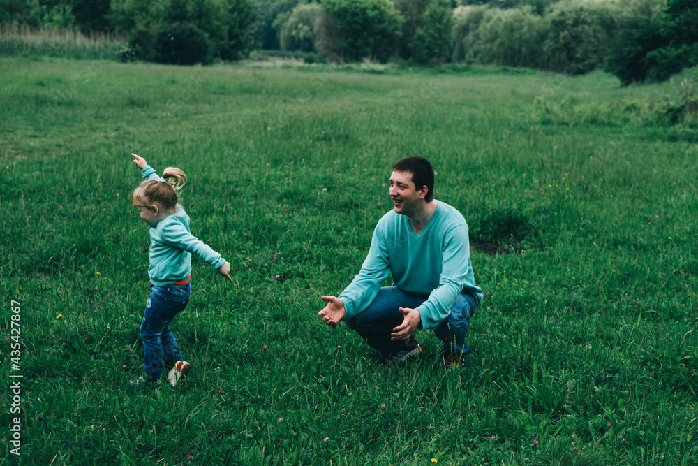 Father Runs With Daughter In A Green Field International Day Of Men father-runs-with-daughter-in-a-green-field-international-day-of-men