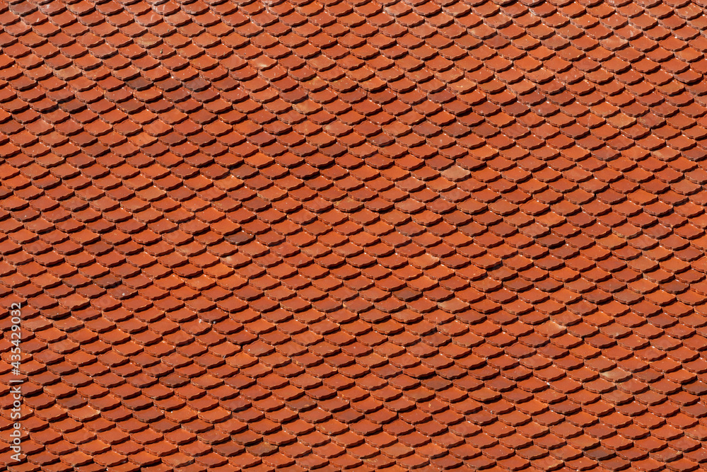 Orange tiles pattern background, Details of new modern orange roof brick, Shingles texture, Abstract geometric pattern, Roof top material of Thai temple. Orange tiles pattern background, Details of new modern orange roof brick, Shingles texture, Abstract geometric pattern, Roof top material of Thai temple.