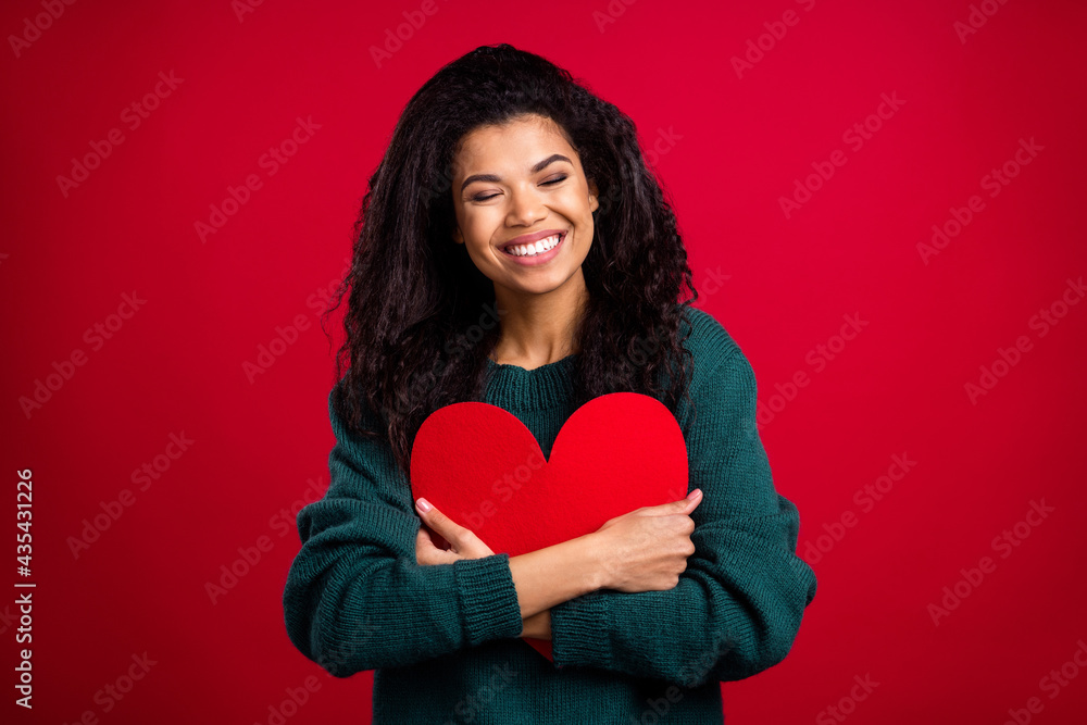 Photo of brunette coquette millennial lady hug heart wear green sweater isolated on red color background Photo of brunette coquette millennial lady hug heart wear green sweater isolated on red color background