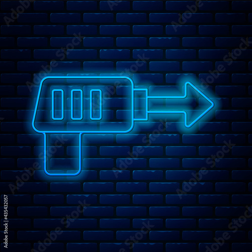 Glowing neon line Fishing harpoon icon isolated on brick wall background. Fishery manufacturers for catching fish under water. Diving underwater equipment. Vector