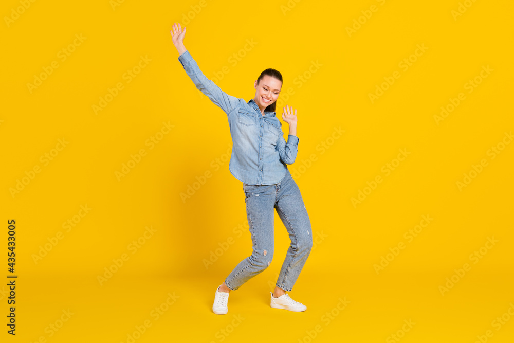 Full length body size photo smiling girl laughing dancing at party on weekend isolated vibrant yellow color background