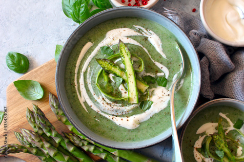 Asparagus and potato cream soup on light background. Top view with copy space. Healthy food.