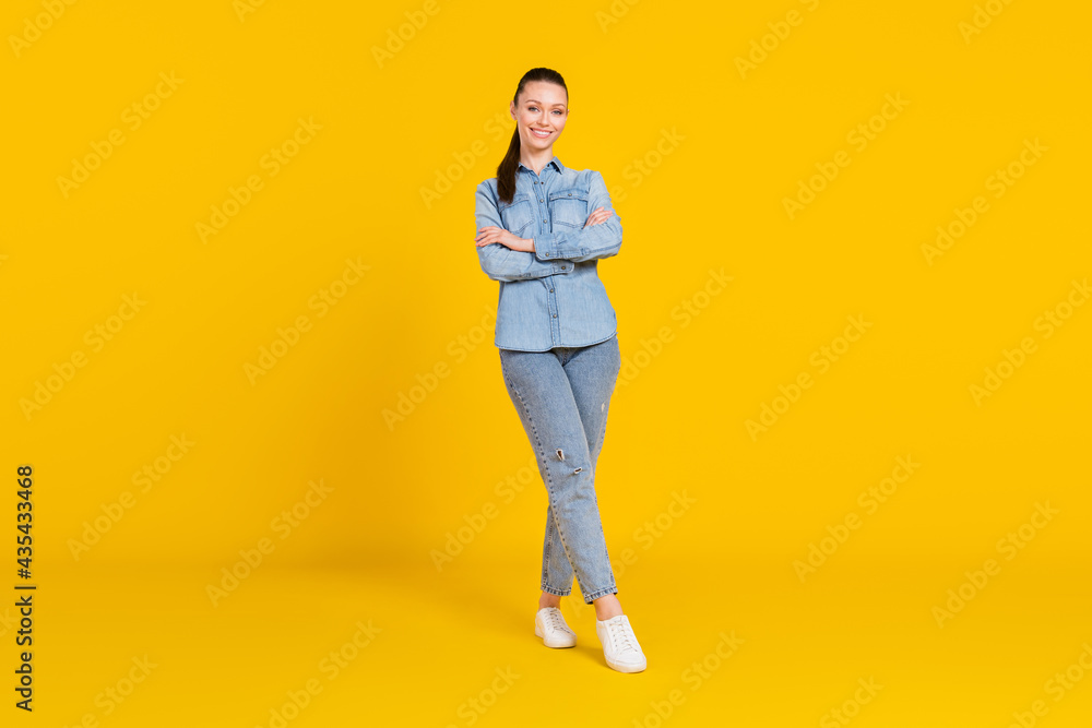 Fototapeta premium Full length body size photo woman smiling with crossed hands isolated vivid yellow color background