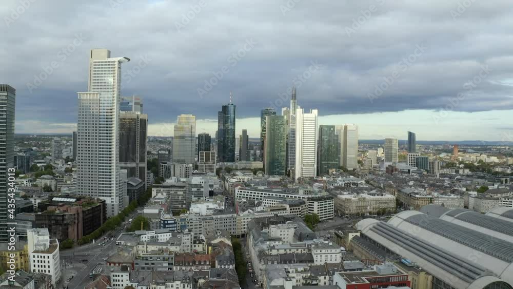 Aerial Moving Towards The Downtown Skyline With Tall Buildings, Gray Skies, Rooftops, And Bustling City Streets - Frankfurt, Germany Aerial Moving Towards The Downtown Skyline With Tall Buildings, Gray Skies, Rooftops, And Bustling City Streets - Frankfurt, Germany
