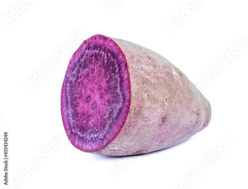 Purple sweet potato cut in half on white background