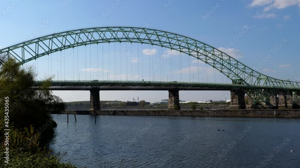Silver Jubilee steel arch Bridge over River Mersey and Manchester Ship Canal, stationary shot from Runcorn side. Silver Jubilee steel arch Bridge over River Mersey and Manchester Ship Canal, stationary shot from Runcorn side.