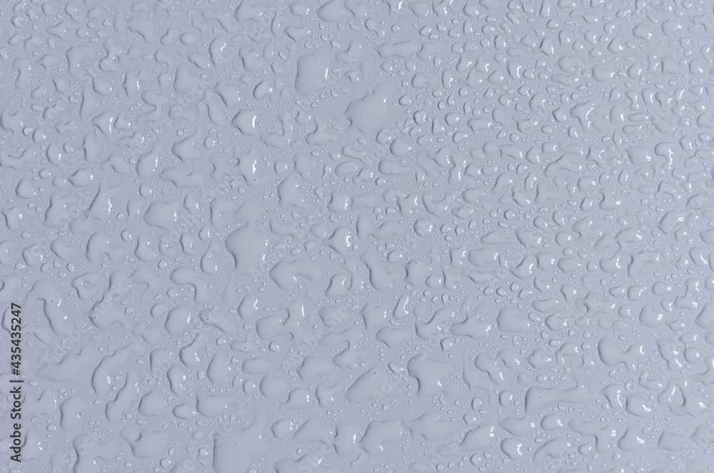 Large and small drops of water on the blue background of the mine space. Texture of water drops top view. Large and small drops of water on the blue background of the mine space. Texture of water drops top view.