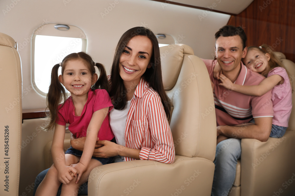 Happy family together in airplane during flight