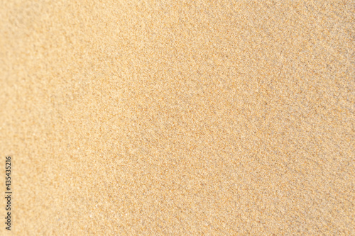 Sand texture background on the beach. Light beige sea sand texture pattern.
